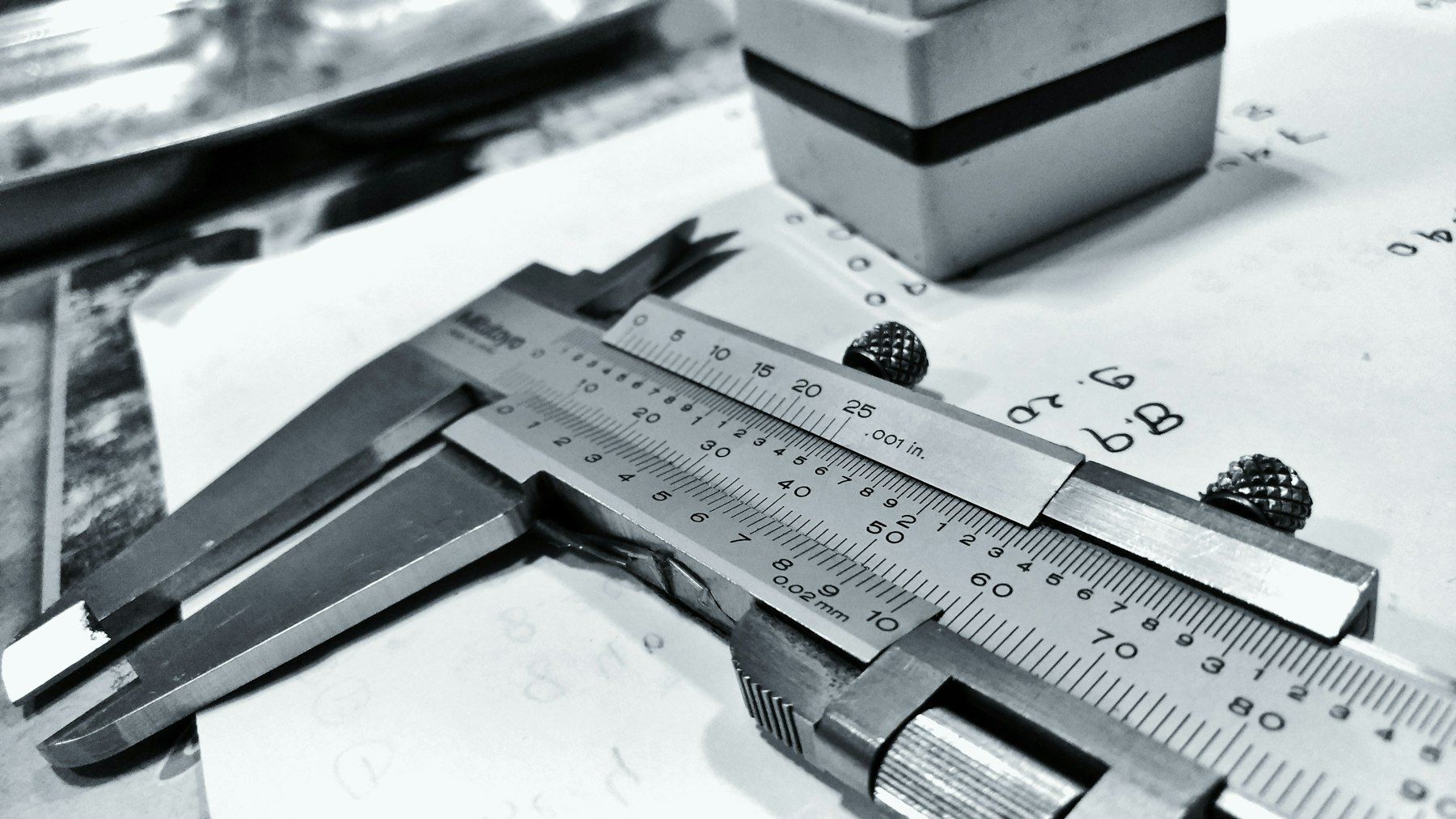 Measuring a machined part with a caliper